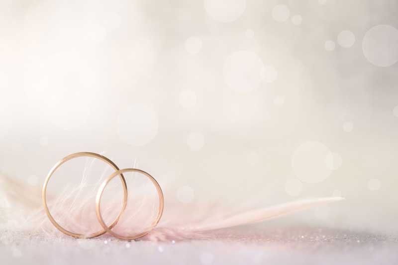 two wedding rings on a table
