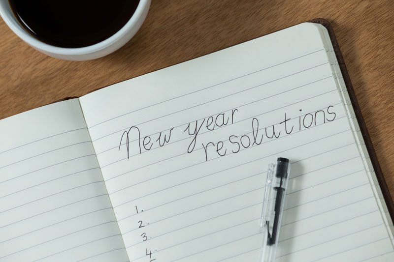 a list of new year's resolutions on paper